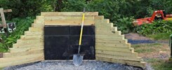 Ballistic rubber blocks from Cumberland Rubber Supply stacked in a shooting range, designed for superior bullet containment. The high-density, vulcanized blocks absorb and encapsulate bullets, preventing ricochet and ensuring a safe live-fire environment.