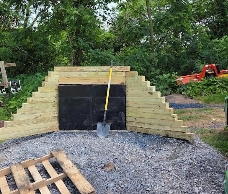 Ballistic rubber blocks from Cumberland Rubber Supply stacked in a shooting range, designed for superior bullet containment. The high-density, vulcanized blocks absorb and encapsulate bullets, preventing ricochet and ensuring a safe live-fire environment.